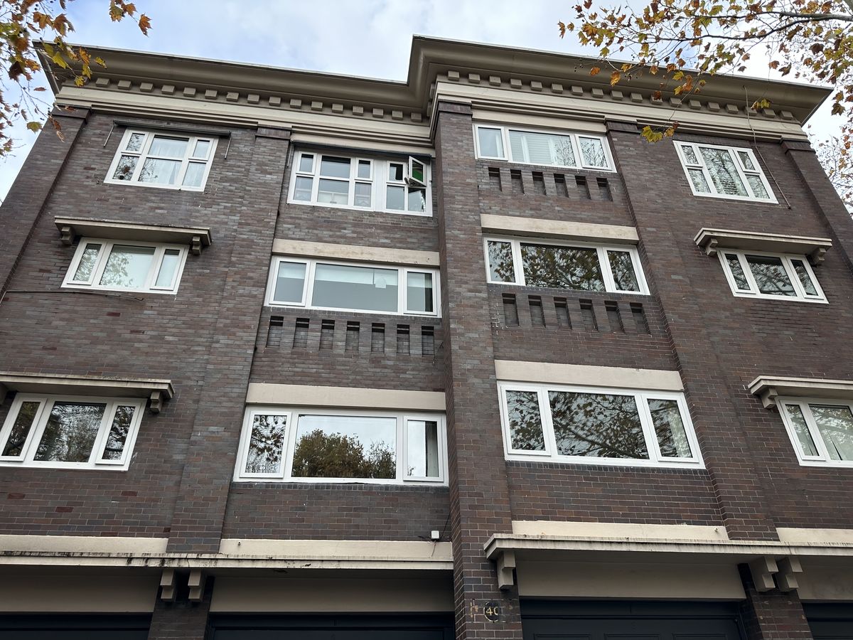 Randwick brick unit block after replacement with white double glazed uPVC casement windows
