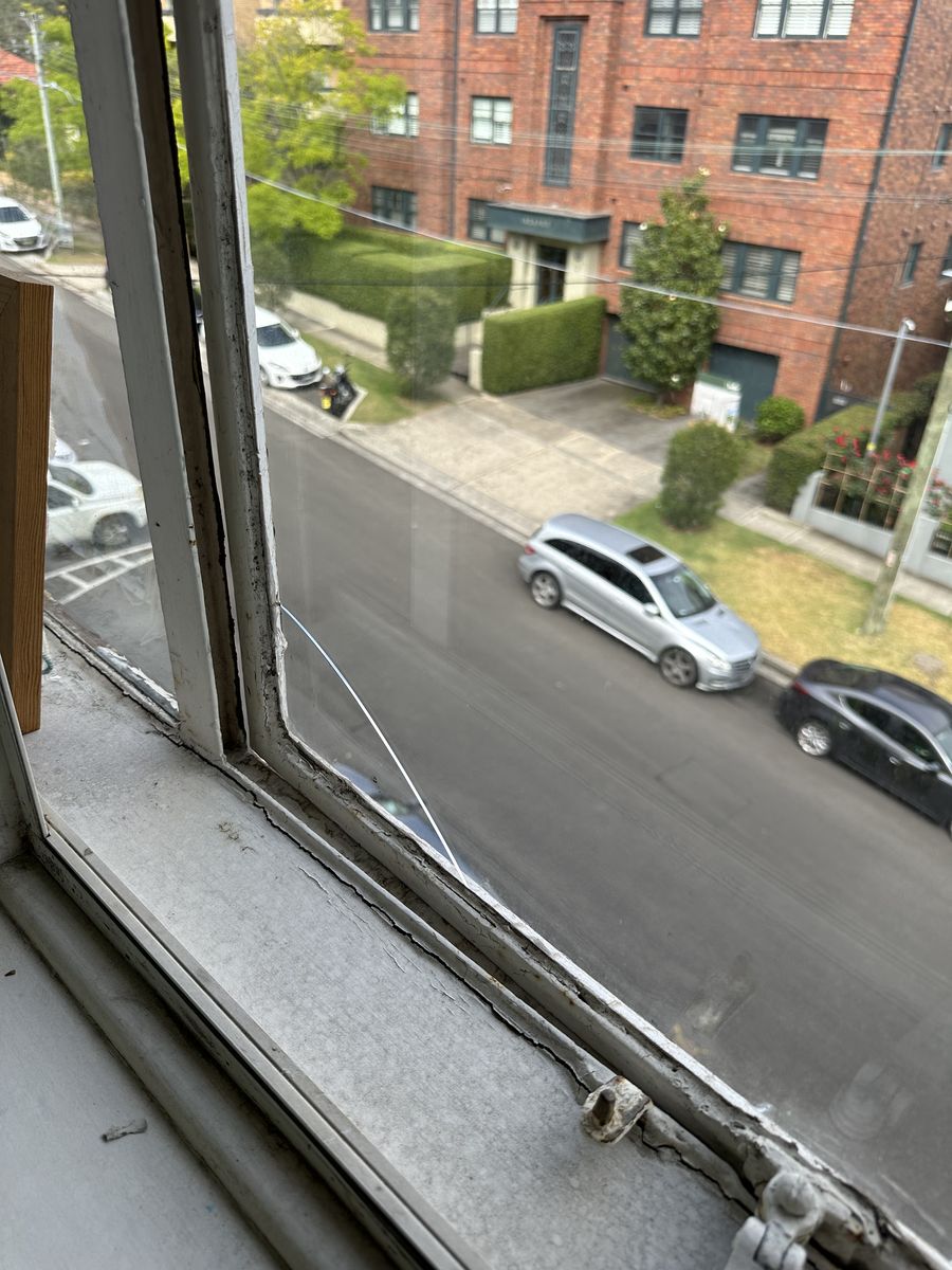 Worn aluminium window frame and sill above the road