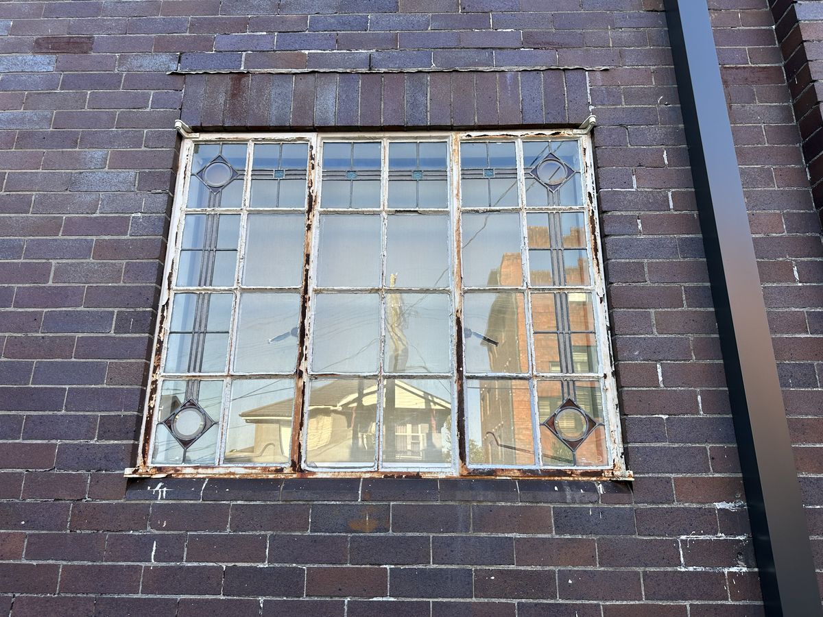 Original steel window with rusted frame on the Randwick building